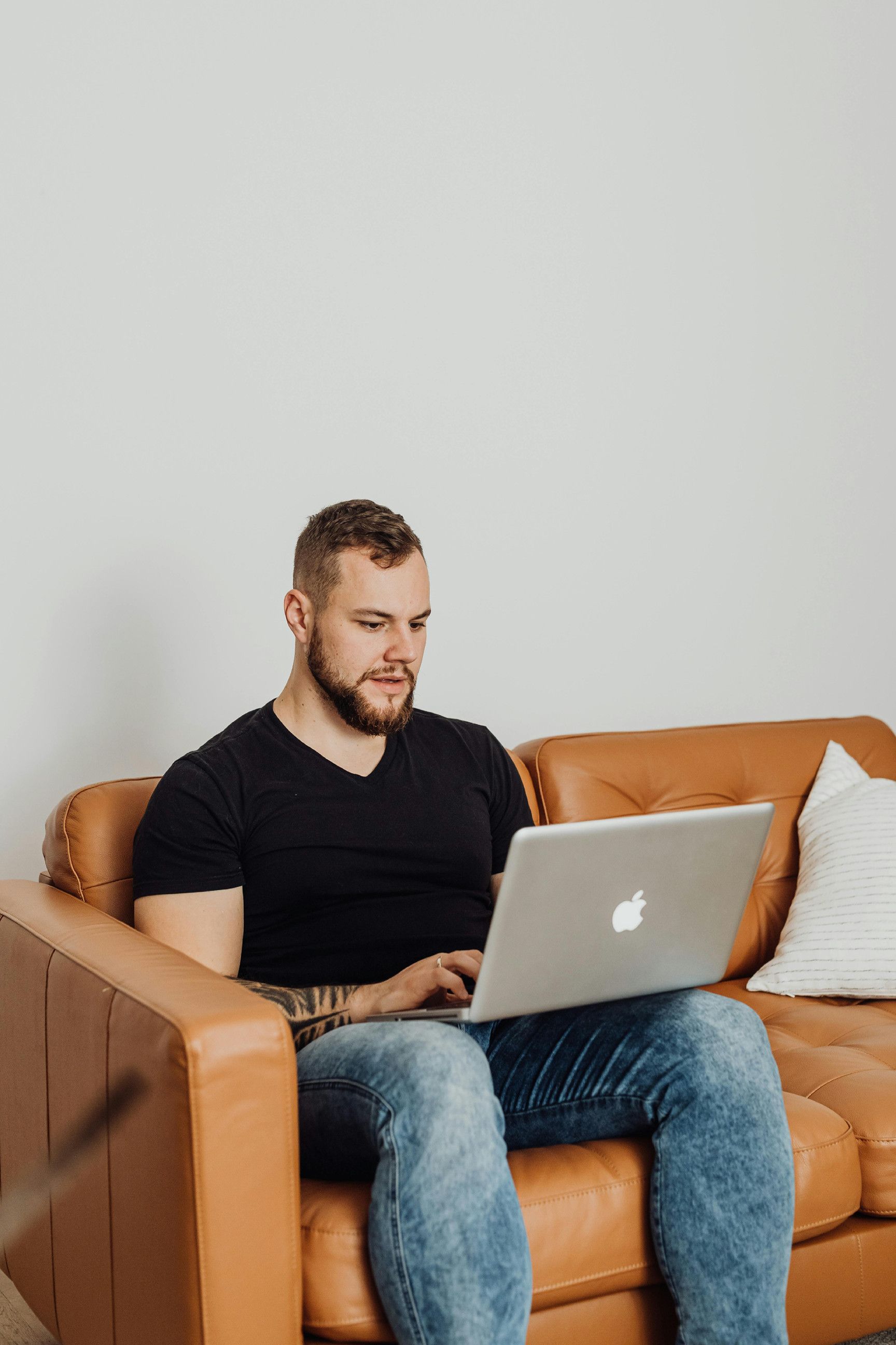 A man consults Doctronic from his living room couch